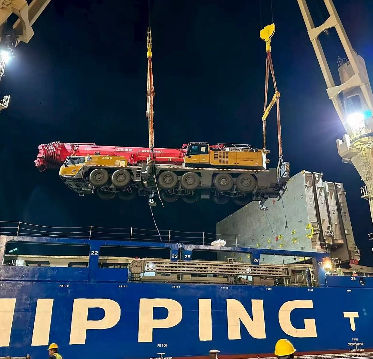 Mobile crane lifted from the hold at night